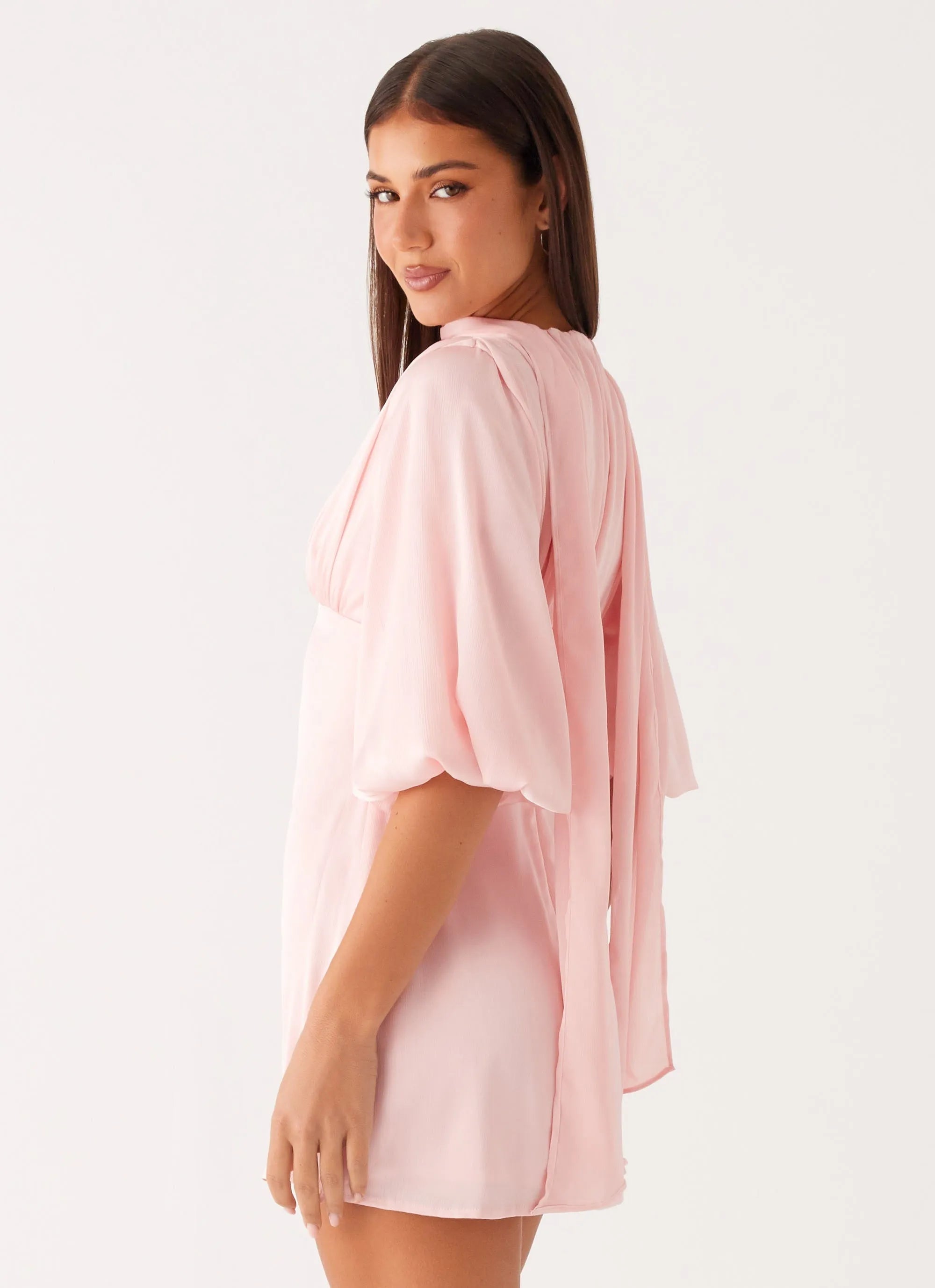 Blush Pink Satin Homecoming Dress with Halter Neckline Deep V Cut Bell Sleeves and Tie - Back Detail
