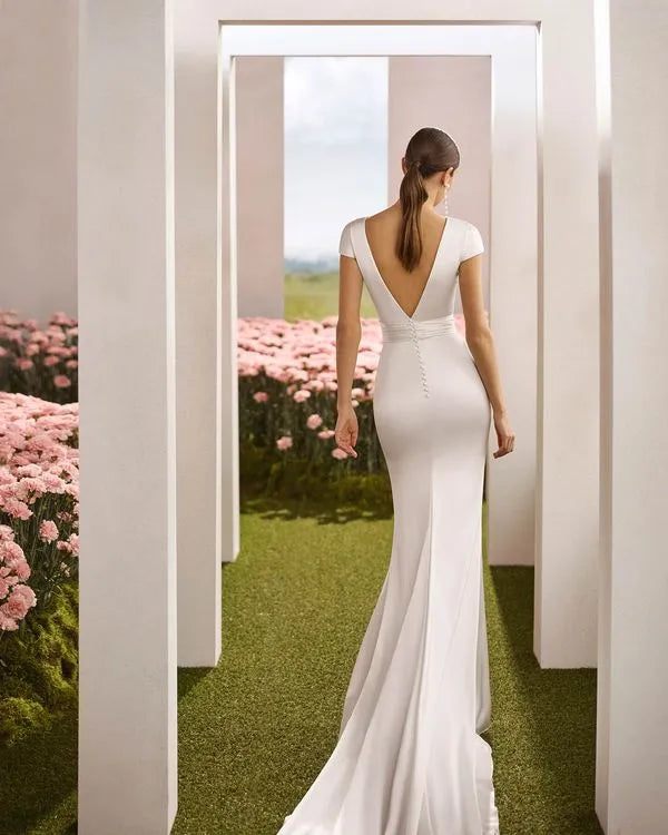 Charming Mermaid Boat Neck Cap Sleeve Button-Back Sweep/Brush Train Wedding Dresses with draped bodice.